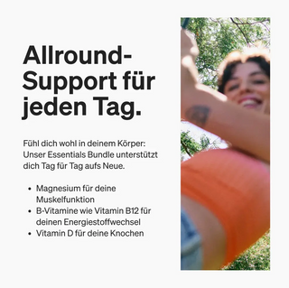 Eine lächelnde Person in einem orangefarbenen Oberteil hält ein Telefon in der Hand, auf dem ein Text steht, der die tägliche Nahrungsergänzung zur Unterstützung von Muskeln, Energie und Knochengesundheit durch Magnesium, B-Vitamine und Vitamin D beschreibt.