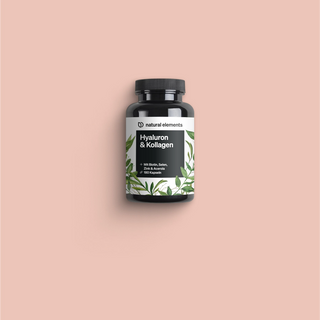 Eine Flasche Vitamin C mit grünen Blättern auf rosa Hintergrund, die die natürlichen Elemente zur Geltung bringt.